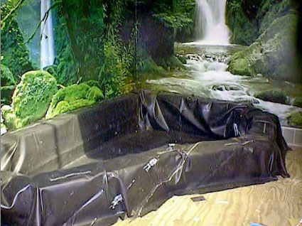 a .45-mil rubber liner is draped over the completed pine plank form to create the water-tight holding area for the pond.
